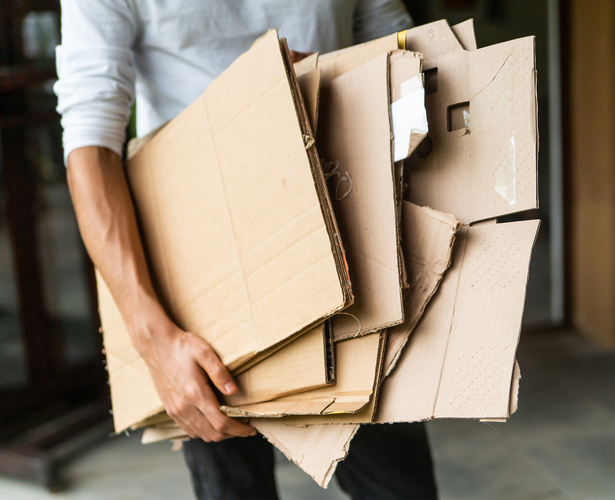 man holding cardboard recycling