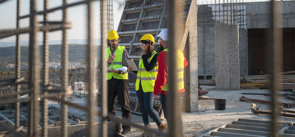construction workers discuss the building plans